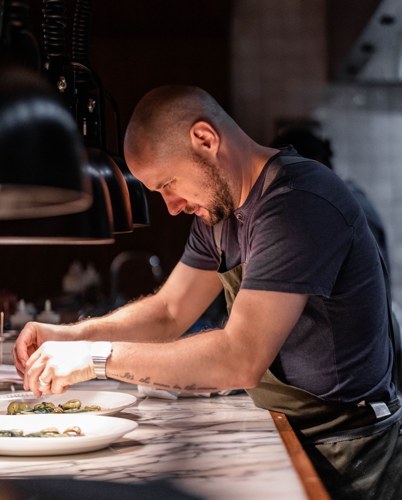 Tom Cenci, Executive Chef at Nessa Soho restaurant, plating up a dish